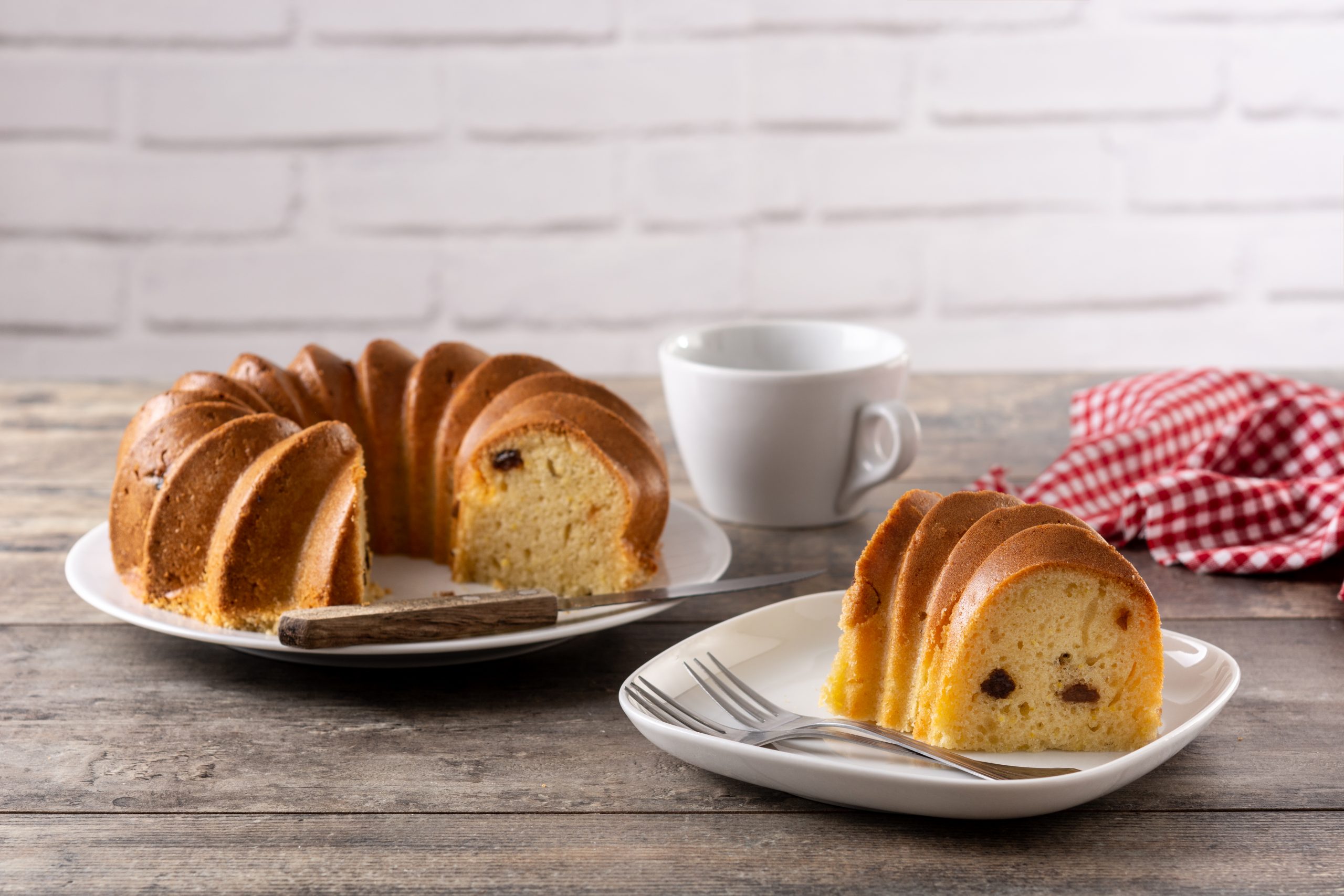 traditional-bundt-cake-piece-with-raisins-wooden-table-scaled.jpg